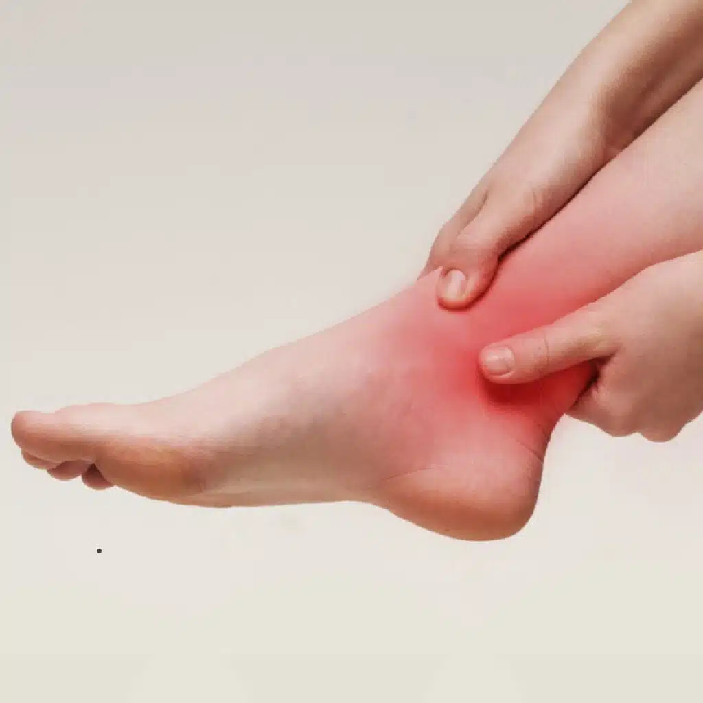 persson clutching a painful ankle (close up)