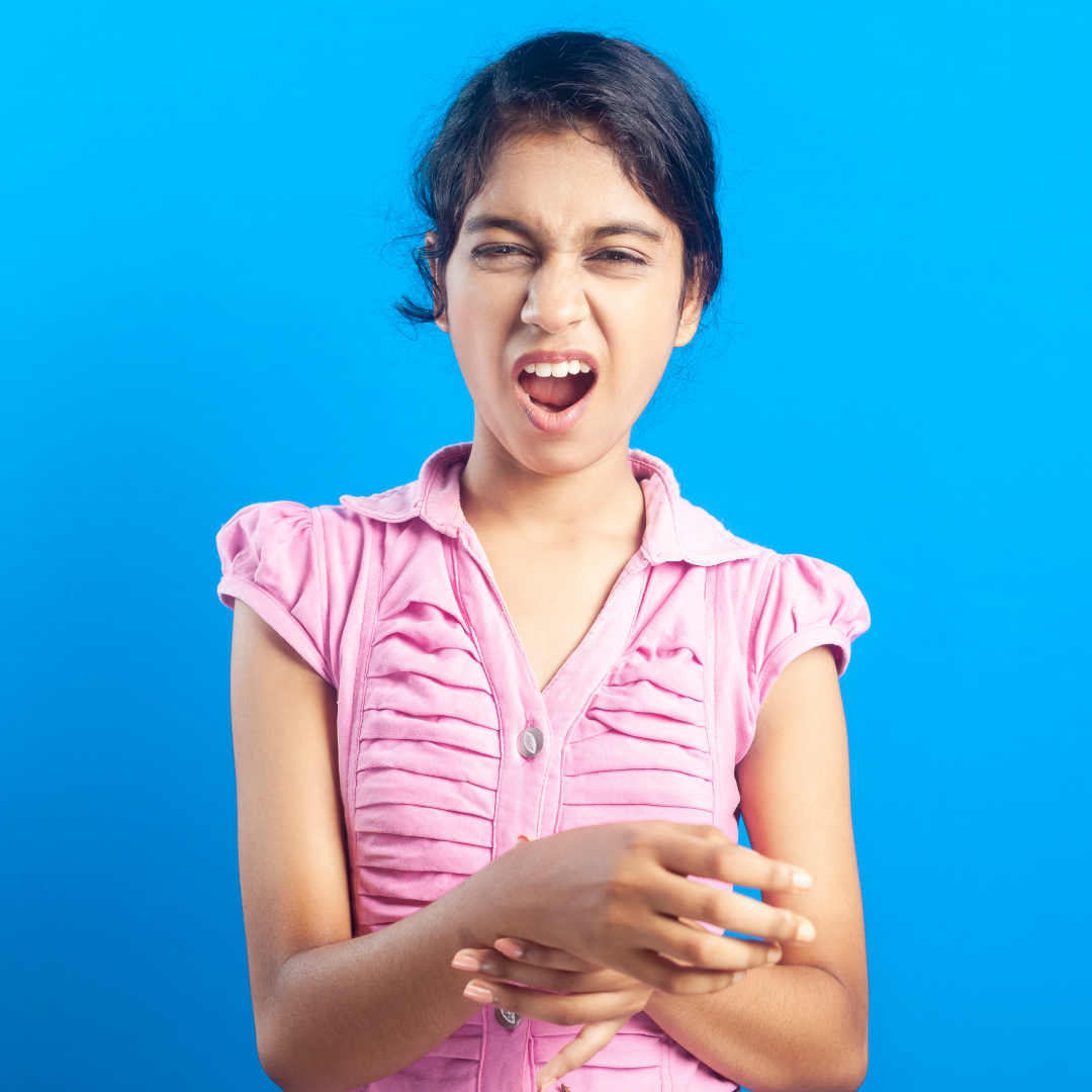 woman yelling and rubbing her wrist to alleviate pain