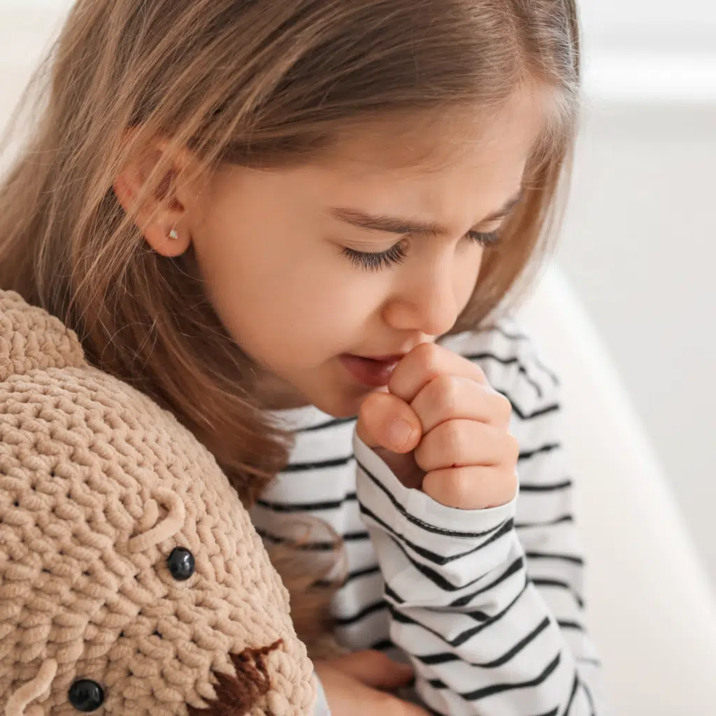 coughing child with teddy bear in need of pediatric acupuncture by Doc Blackstone