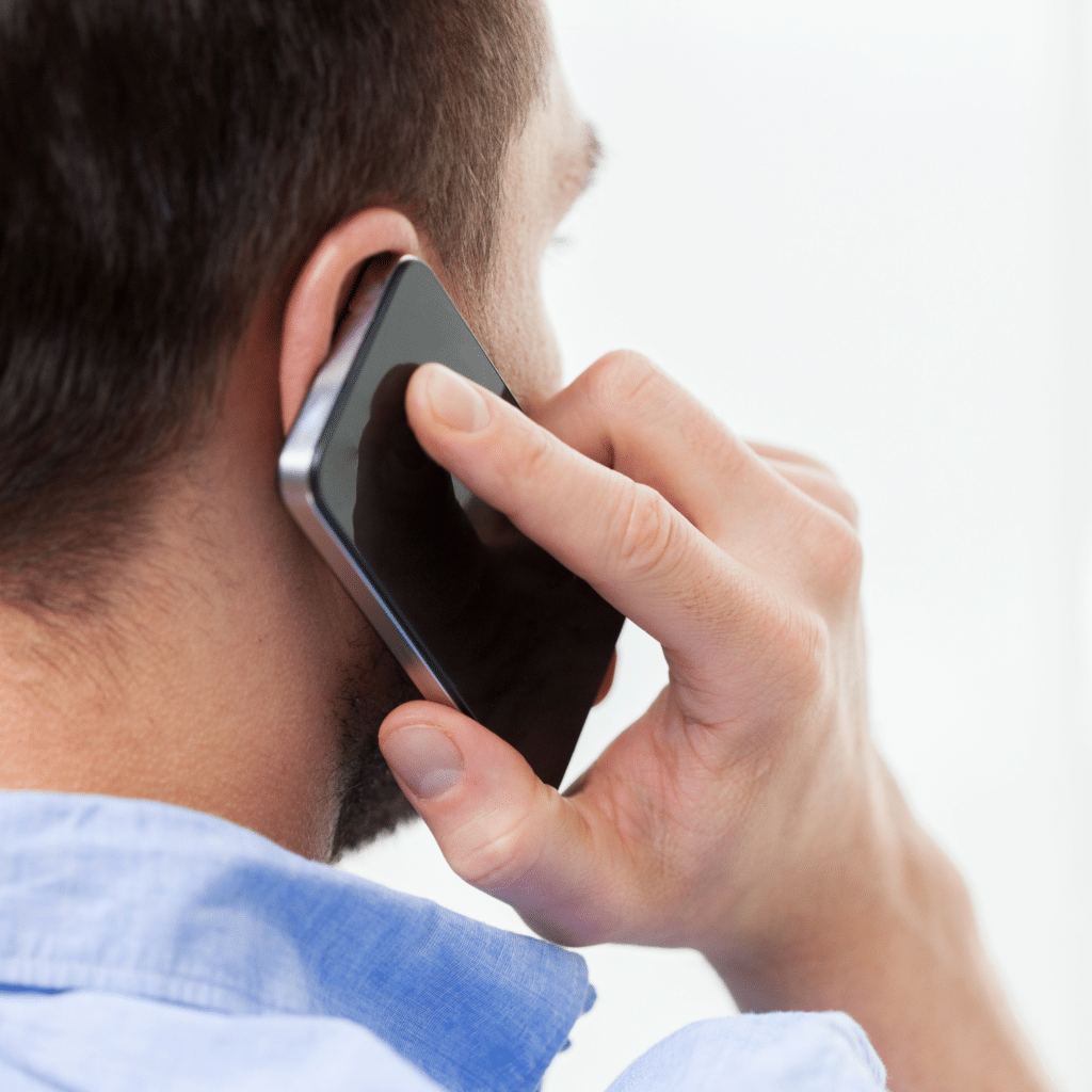 rear view of man calling Doc Blackstone on his cel phone to schedule an appointment