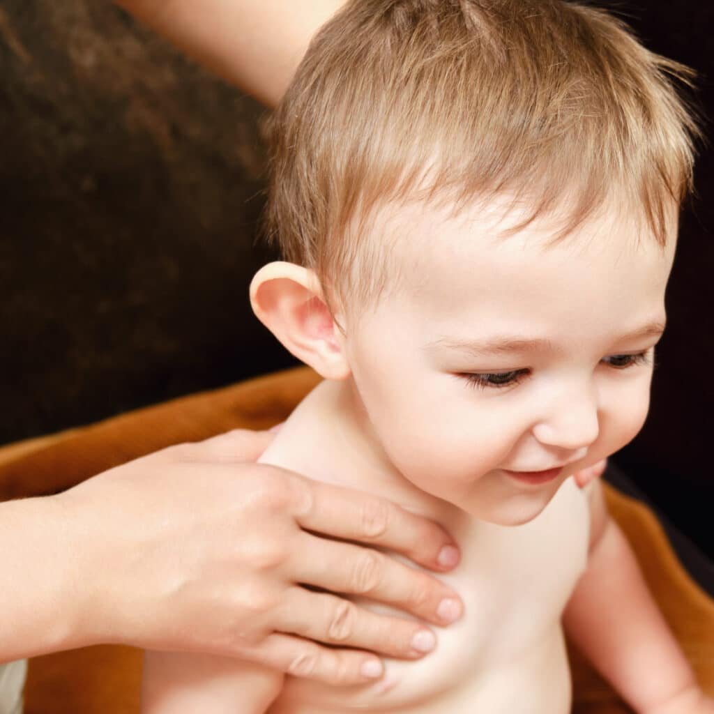 child remaining seated for pediatric acupuncture or Chinese tui na