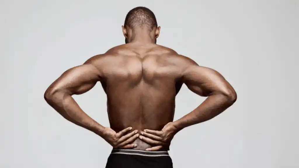 man grasping his lower back from pain